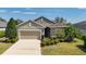 Charming single-Gathering home featuring a two-car garage, well-maintained landscaping and a welcoming front entrance at 5011 Kincaid Park Ln, Bradenton, FL 34211