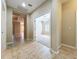 Spacious hallway with tile flooring and neutral walls leading to different areas of the home at 5011 Kincaid Park Ln, Bradenton, FL 34211
