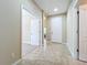 Hallway featuring tile flooring, neutral walls, and white doors providing access to various rooms at 5011 Kincaid Park Ln, Bradenton, FL 34211