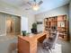 Bright office space with a ceiling fan, desk, shelving and natural light from windows overlooking backyard at 5011 Kincaid Park Ln, Bradenton, FL 34211