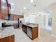 Well-equipped kitchen featuring stainless steel appliances, granite countertops, dark cabinetry and tile flooring at 5011 Kincaid Park Ln, Bradenton, FL 34211