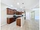 Spacious kitchen featuring dark wood cabinets, granite countertops, stainless steel appliances, and a center island at 5011 Kincaid Park Ln, Bradenton, FL 34211