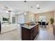 Open kitchen with a granite-topped island flowing into the living and dining areas, perfect for entertaining at 5011 Kincaid Park Ln, Bradenton, FL 34211