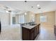 Open kitchen featuring granite countertops, stainless steel appliances, tile flooring, and adjacent living area at 5011 Kincaid Park Ln, Bradenton, FL 34211