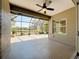 Screened lanai with ceiling fan overlooking the lush backyard at 5011 Kincaid Park Ln, Bradenton, FL 34211