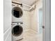 Convenient laundry room equipped with a stacked washer and dryer at 5011 Kincaid Park Ln, Bradenton, FL 34211