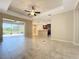 Open-concept living space with tile flooring seamlessly connects to the kitchen and outdoor area at 5011 Kincaid Park Ln, Bradenton, FL 34211