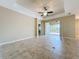 Spacious living room with tile floors, ceiling fan and access to the lanai with a view of the community lake at 5011 Kincaid Park Ln, Bradenton, FL 34211
