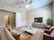 Bright living room featuring a ceiling fan, neutral paint, and contemporary furnishings at 5011 Kincaid Park Ln, Bradenton, FL 34211