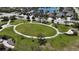 Beautiful community park featuring a large oval green space surrounded by walking paths and seating at 5011 Kincaid Park Ln, Bradenton, FL 34211