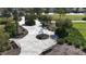 Scenic walking path and seating area to enjoy the outdoors with shady trees, benches, and landscaping at 5011 Kincaid Park Ln, Bradenton, FL 34211