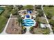 Aerial view of the community playground featuring a splash pad, swings, and playground equipment in a park-like setting at 5011 Kincaid Park Ln, Bradenton, FL 34211