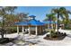Stunning image of poolside pavilions complete with picnic tables and shaded seating areas at 5011 Kincaid Park Ln, Bradenton, FL 34211