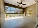 The screened-in lanai features a ceiling fan with views of the lake at 5011 Kincaid Park Ln, Bradenton, FL 34211