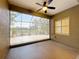 The screened-in lanai features a ceiling fan and shutters at 5011 Kincaid Park Ln, Bradenton, FL 34211
