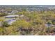 An aerial view highlighting the neighborhood, mature trees, and community pool at 5117 27Th W St # 5117, Bradenton, FL 34207