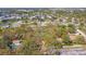An aerial view showcasing a serene neighborhood with mature landscaping and glimpses of a sparkling pool at 5117 27Th W St # 5117, Bradenton, FL 34207