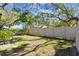 Fenced backyard featuring a beautiful lawn and palm trees, offering privacy and a tropical feel at 5117 27Th W St # 5117, Bradenton, FL 34207