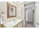 Clean bathroom features a large framed mirror, white countertops, and convenient storage space at 5117 27Th W St # 5117, Bradenton, FL 34207