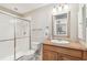 Bright bathroom featuring a tiled shower with glass doors, neutral paint, and a granite countertop at 5117 27Th W St # 5117, Bradenton, FL 34207
