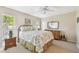 Cozy bedroom with ceiling fan, warm carpet, and natural light creates a relaxing atmosphere at 5117 27Th W St # 5117, Bradenton, FL 34207