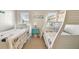 Bright bedroom with a bunk bed, twin bed, colorful fish decor, and a turquoise nightstand at 5117 27Th W St # 5117, Bradenton, FL 34207