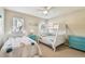Bright bedroom with a bunk bed, twin bed, colorful fish decor, and a turquoise dresser at 5117 27Th W St # 5117, Bradenton, FL 34207