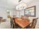 The dining area features a stylish light fixture and a decorative mirror, complemented by a wooden table at 5117 27Th W St # 5117, Bradenton, FL 34207
