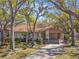Home featuring mature trees in the front yard with a covered carport and tidy landscaping at 5117 27Th W St # 5117, Bradenton, FL 34207
