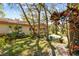 Home exterior with mature landscaping, trees, neutral paint, a carport, and a long driveway at 5117 27Th W St # 5117, Bradenton, FL 34207