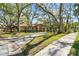 Home with mature landscaping, trees, neutral paint, a carport, and a sidewalk at 5117 27Th W St # 5117, Bradenton, FL 34207