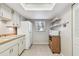 Well-lit kitchen features white appliances, wood cabinets, and a window with natural light to brighten the space at 5117 27Th W St # 5117, Bradenton, FL 34207