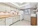 Bright kitchen featuring tile floors, neutral paint, a window, and white appliances at 5117 27Th W St # 5117, Bradenton, FL 34207