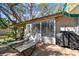 Back patio area includes lounge chairs, a grill, and a paved surface ideal for outdoor relaxation and entertainment at 5117 27Th W St # 5117, Bradenton, FL 34207