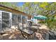Back patio area with chaise lounges and a grill, offering a comfortable and functional outdoor living space at 5117 27Th W St # 5117, Bradenton, FL 34207