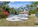 Community pool area featuring lounge chairs, mature landscaping, and a pool-side building at 5117 27Th W St # 5117, Bradenton, FL 34207