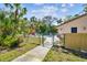 A gated community pool area, showcasing lush greenery, chairs, and clear blue water at 5117 27Th W St # 5117, Bradenton, FL 34207