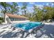 Inviting community pool with sparkling water, surrounded by mature trees, offering a serene setting for swimming and leisure at 5117 27Th W St # 5117, Bradenton, FL 34207