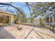 Screened-in patio with brick flooring, fountain, and serene lake view at 519 Habitat Blvd, Osprey, FL 34229