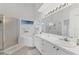 Bright bathroom features a shower, a tub, a white vanity and a large mirror at 5240 Hyland Hills Ave # 1426, Sarasota, FL 34241