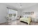 Bright bedroom featuring a cozy seating area and a comfortable bed with views from the expansive windows at 5240 Hyland Hills Ave # 1426, Sarasota, FL 34241