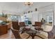 Bright dining area with a glass table and wicker chairs offering serene views from the adjacent living spaces at 5240 Hyland Hills Ave # 1426, Sarasota, FL 34241