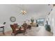 Open dining area with views of the living room and outdoor balcony at 5240 Hyland Hills Ave # 1426, Sarasota, FL 34241