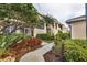 Condo exterior featuring lush landscaping and a private screened porch at 5240 Hyland Hills Ave # 1426, Sarasota, FL 34241