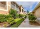 The exterior of the condo features a screened in porch and lush landscaping at 5240 Hyland Hills Ave # 1426, Sarasota, FL 34241