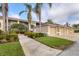 Well-maintained condo building with attached garages and mature landscaping at 5240 Hyland Hills Ave # 1426, Sarasota, FL 34241