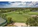 Scenic aerial view of the golf course featuring lush green fairways and mature trees at 5240 Hyland Hills Ave # 1426, Sarasota, FL 34241