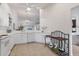 Well-lit kitchen featuring white cabinetry, updated appliances, and stylish decorative touches on a tiled floor at 5240 Hyland Hills Ave # 1426, Sarasota, FL 34241