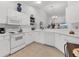 Bright kitchen with ample counter space, white appliances, and an open design for easy entertaining and cooking at 5240 Hyland Hills Ave # 1426, Sarasota, FL 34241