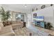 Open-concept living room with stylish furnishings and access to a balcony at 5240 Hyland Hills Ave # 1426, Sarasota, FL 34241